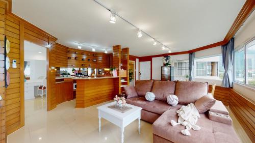 a living room with a couch and a table at Mountain & City View Panorama at Nimman in Chiang Mai