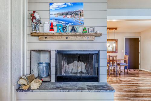 a living room with a fireplace with a tv above it at Alpine Condo #A5 in Brian Head