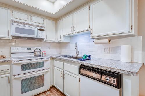 a kitchen with white cabinets and a sink at Alpine Condo #A5 in Brian Head