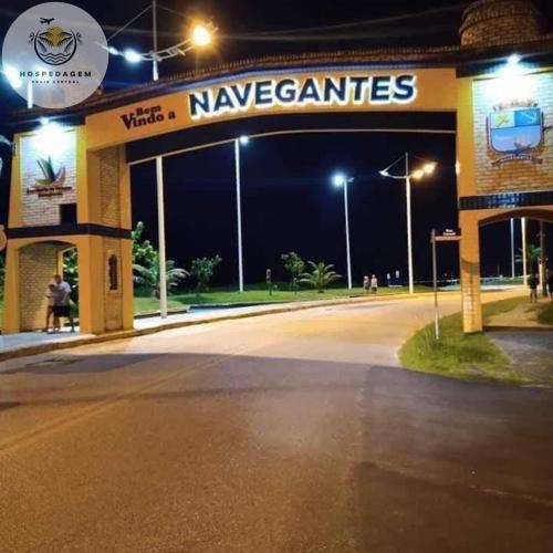 a gas station at night with a sign on it at Hospedagem Praia Central in Navegantes