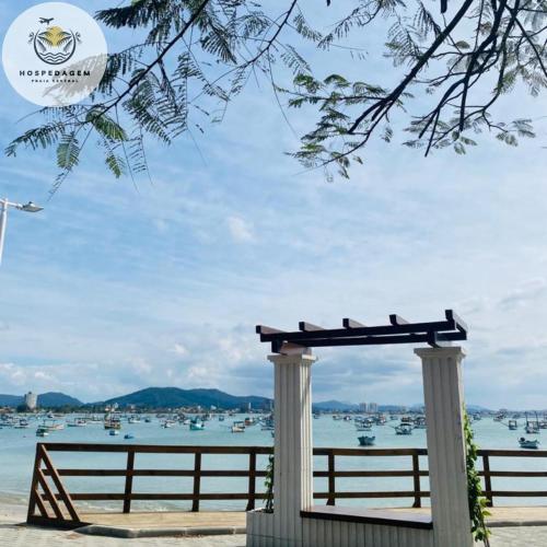 a bench with a view of the water at Hospedagem Praia Central in Navegantes