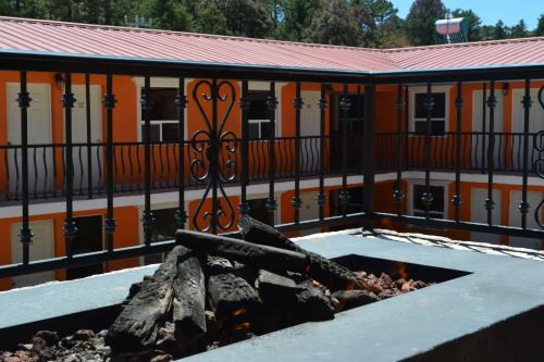 a fire pit in front of an orange building at Villa Santa Cruz Creel in Creel