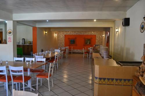 a dining room with tables and chairs in a restaurant at Villa Santa Cruz Creel in Creel