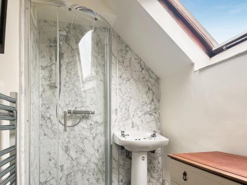 a bathroom with a sink and a shower at Meadow View Cottage in Highpeak Junction