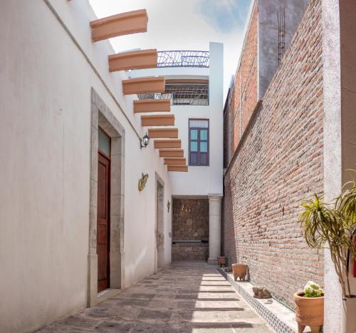 un callejón en un edificio con una pared de ladrillo en Casa De Los Remedios Morelia en Morelia