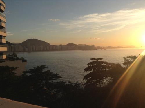 a view of a body of water at sunset at Guaruja Apartment in Guarujá