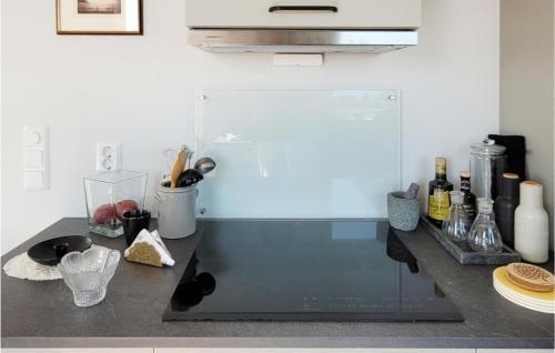 a kitchen with a counter with a sink and a stove at Beautiful Home In Bremnes With Wifi in Bremnes