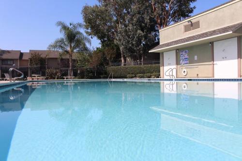 a large swimming pool in front of a building at MAGICAL Xcape, POOLS-SPA, WALK 2 DISNEY, CENTRAL AC-HEAT, FULLY EQUIPPED, 2 FREE PARKING SPACES, OWNER MGMT in Anaheim