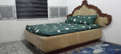 a bed sitting in a corner of a room at D'Bukit Homestay in Pengerang