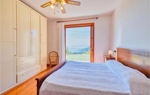a bedroom with a bed and a large window at Beautiful Home In Recco With Kitchen in Recco