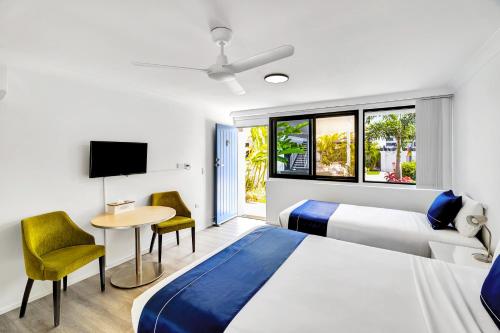 una camera d'albergo con letto, tavolo e sedie di Montego Mermaid Beach Motel a Gold Coast