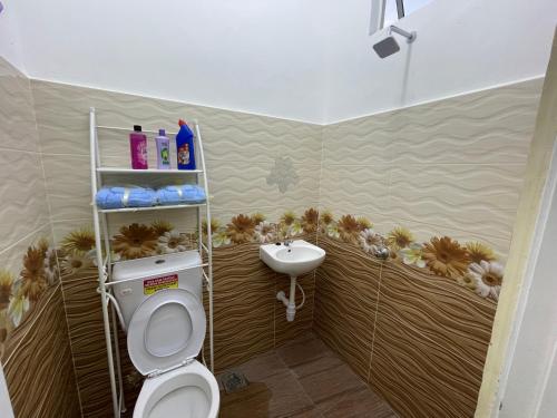 a bathroom with a toilet and a sink at Teratak Sakinah Guest House in Tambun