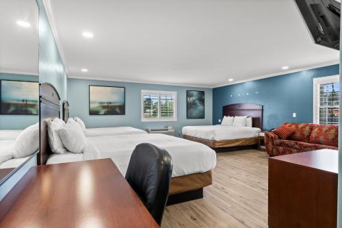 ein Hotelzimmer mit 2 Betten und einem Tisch in der Unterkunft Executive Inn & Suites Magnolia in Magnolia