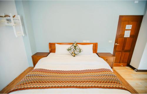 a bedroom with a bed with a pillow on it at Na Jie 17 in Donghe