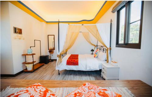 a bedroom with a bed with a canopy at Na Jie 17 in Donghe