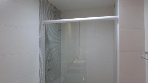 a shower with a glass door in a bathroom at 439 Barrabela in Rio de Janeiro