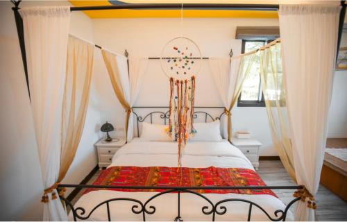 a bedroom with a bed with a canopy at Na Jie 17 in Donghe