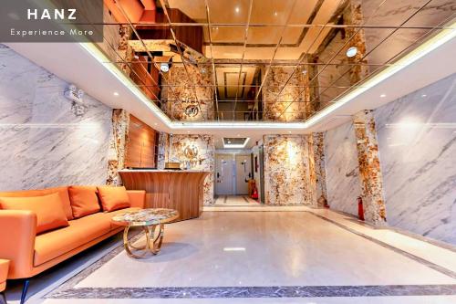 a lobby with an orange couch and a table at S79 My My Hotel 2 in Ho Chi Minh City
