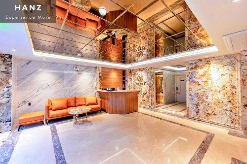 a lobby with an orange couch and a table at S79 My My Hotel 2 in Ho Chi Minh City