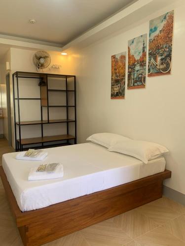 a bedroom with a large bed with posters on the wall at MAMORI HOTEL in Allen