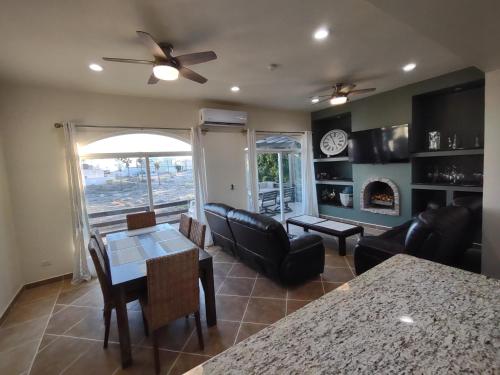 a living room with a couch and a table and chairs at *3BR/2 KING Suites/3.5 BATH Rooftop w/Ocean Views in Puerto Peñasco