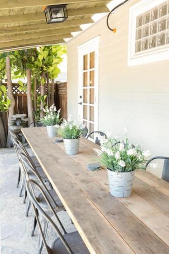 a long wooden table with chairs and potted plants at 4221 Urban oasis in Hillcrest Mission Hills in San Diego