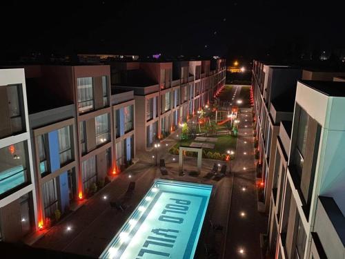 an overhead view of a building with a swimming pool at Liana Polo Villas Parklane in Batumi