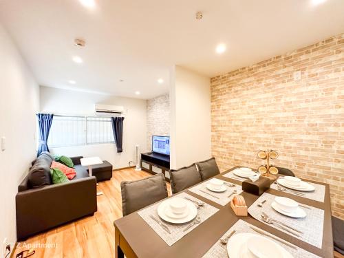 a dining room and living room with a table and chairs at Z Apartment大阪 環球影城 USJ 一戶建 歡迎二人入住 in Osaka