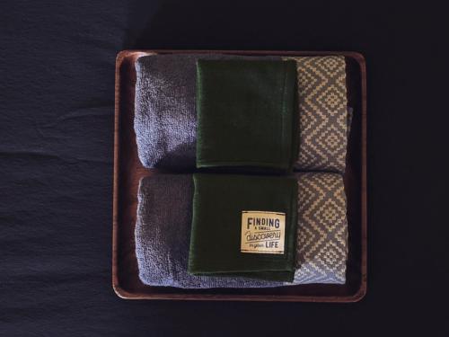 a wooden tray with a box of playing cards at Here Library - A wooden home by the river with a library in Thốt Nốt