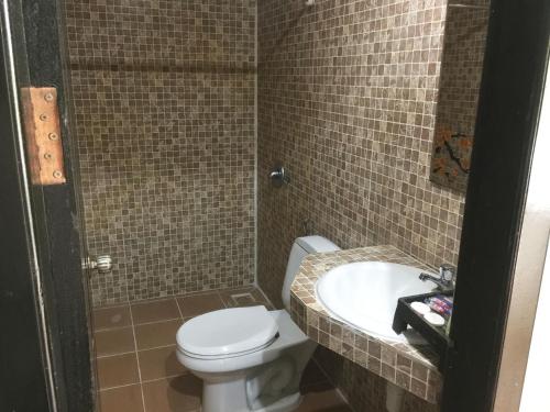 a bathroom with a toilet and a sink at Central Night Hotel in Siem Reap