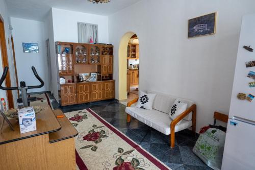 a living room with a couch and a table at Panoramic View House in Tepelenë