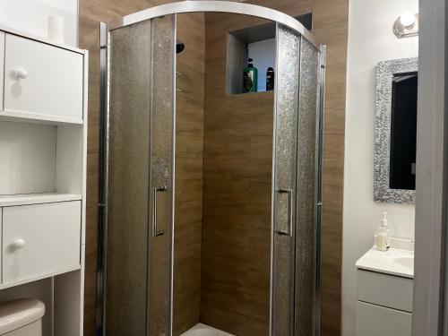 a shower with a glass door in a bathroom at hidden valley new basement suite with private bathroom! in Calgary
