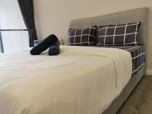 a bedroom with a large bed with two pillows at Icon Residenz Icon City, Petaling Jaya by De Harlequins Guesthouse in Petaling Jaya