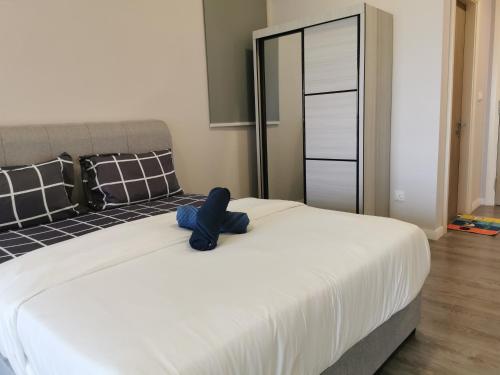 a large white bed with a blue stuffed animal on it at Icon Residenz Icon City, Petaling Jaya by De Harlequins Guesthouse in Petaling Jaya