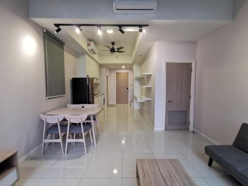 a living room with a table and a kitchen at Icon Residenz Icon City, Petaling Jaya by De Harlequins Guesthouse in Petaling Jaya