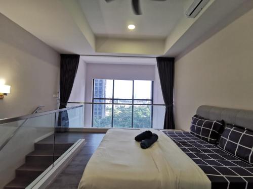 a bedroom with a bed with a glass floor at Icon Residenz Icon City, Petaling Jaya by De Harlequins Guesthouse in Petaling Jaya