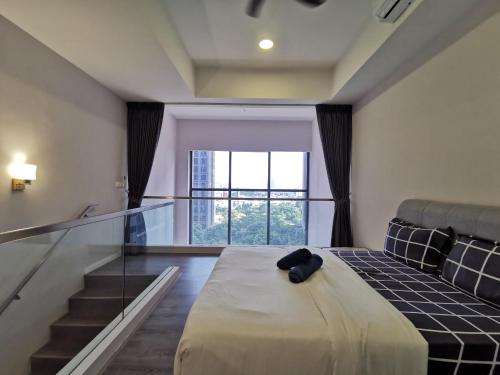 a bedroom with a bed with a glass floor at Icon Residenz Icon City, Petaling Jaya by De Harlequins Guesthouse in Petaling Jaya