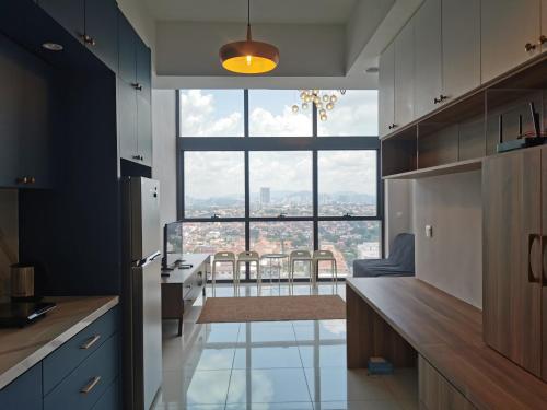 a kitchen with a large window with a view at Icon Residenz Icon City, Petaling Jaya by De Harlequins Guesthouse in Petaling Jaya