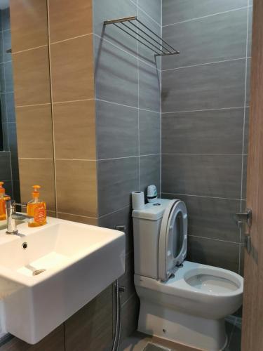 a bathroom with a white sink and a toilet at Icon Residenz Icon City, Petaling Jaya by De Harlequins Guesthouse in Petaling Jaya