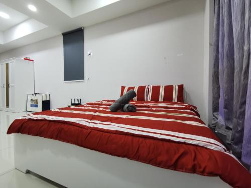 a teddy bear sitting on a bed in a bedroom at Icon Residenz Icon City, Petaling Jaya by De Harlequins Guesthouse in Petaling Jaya
