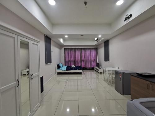 a living room with a couch and a table at Icon Residenz Icon City, Petaling Jaya by De Harlequins Guesthouse in Petaling Jaya