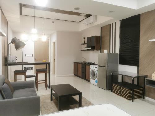 a living room and kitchen with a couch and a table at Icon Residenz Icon City, Petaling Jaya by De Harlequins Guesthouse in Petaling Jaya