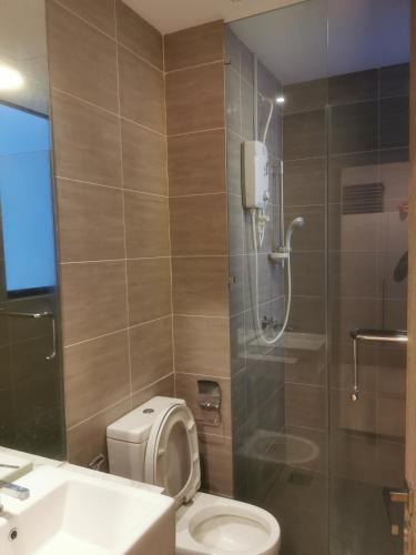 a bathroom with a shower and a toilet and a sink at Icon Residenz Icon City, Petaling Jaya by De Harlequins Guesthouse in Petaling Jaya