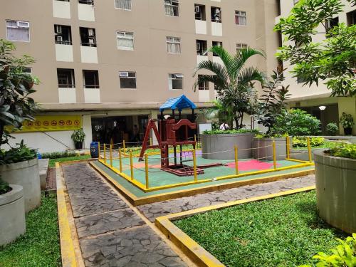 a playground in the courtyard of a building at Apartemen kalibata city By Alia Property in Jakarta