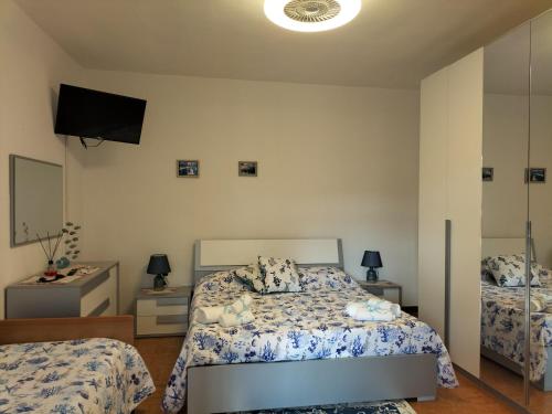 a bedroom with a bed and a television in it at Casa stella marina Villasimius.. in Villasimius