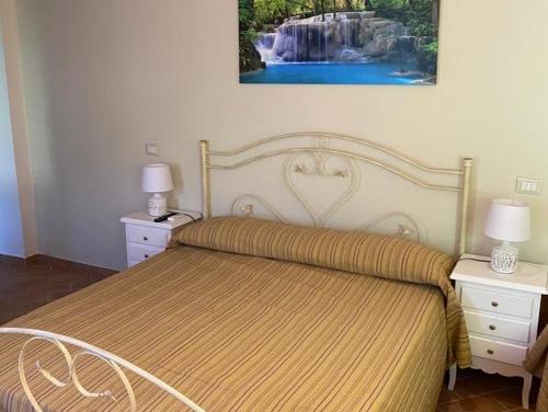 a bedroom with a bed with a waterfall painting on the wall at DOLCE DORMIRE in Albanella