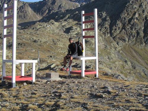 a man sitting on a ladder on top of a mountain at Aktivurlaub Morandell in Sölden