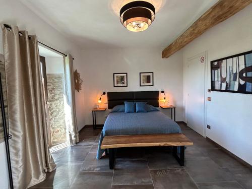 a bedroom with a bed with a blue comforter at Cascina Malinverni in Rocchetta Palafea