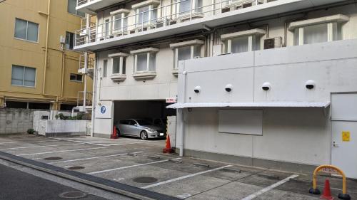 a car parked in a parking lot next to a building at Hotel Harbour Yokosuka in Yokosuka