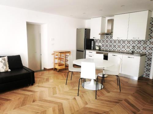 a kitchen and a living room with a table and chairs at Casa Rocca in Roccaforte Mondovì
